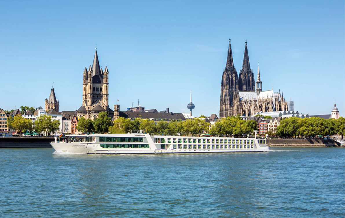 A luxury river ship sails past Cologne Cathedral
