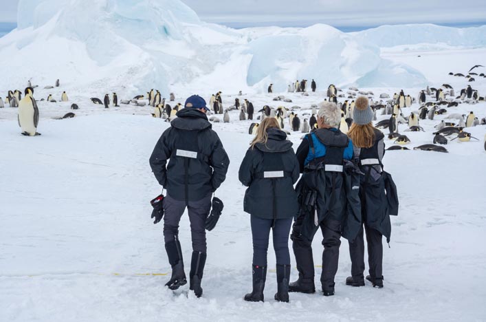 Scenic Eclipse guests at Snow Hill Island looking at Emperor Penguins
