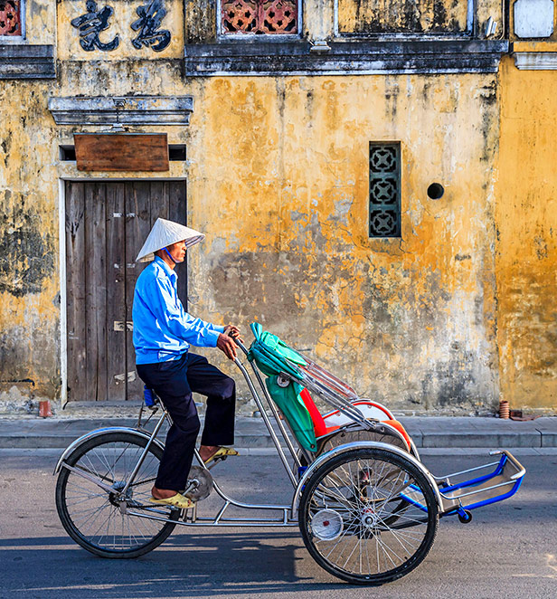 A local riding a Cyclo in the streets of Hoi An