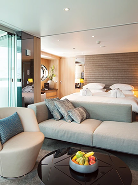 The lounge area and queen bed in the Royal Panorama Suite