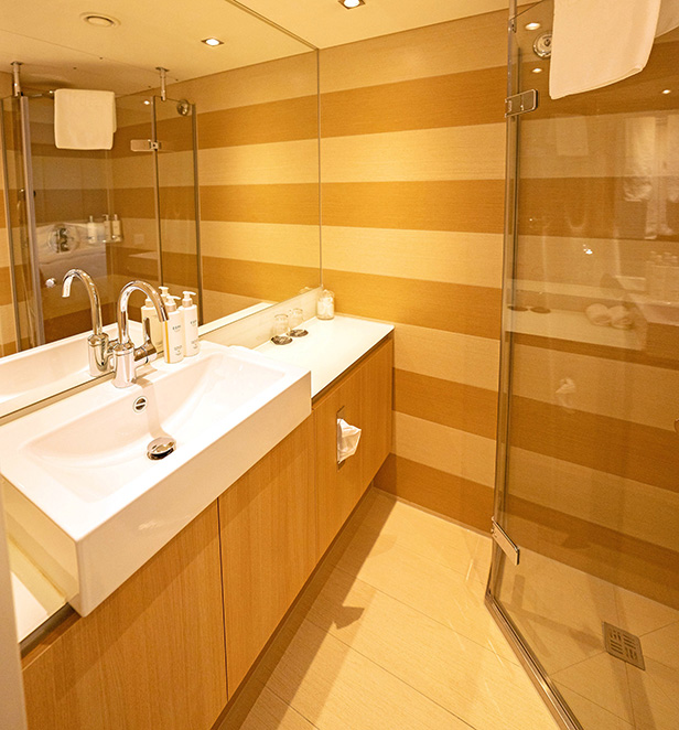 Luxurious bathroom with vanity and shower in a Scenic river cruise suite.