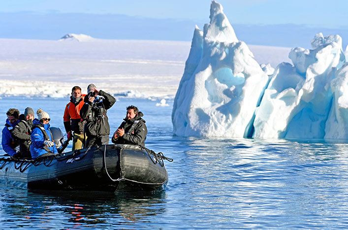 black zodiac with an iceberg in the background